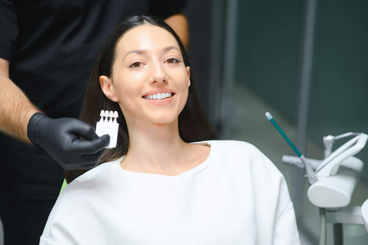 A dentist measuring teeth whitening with veneers plate at the dental office in Colorado Springs