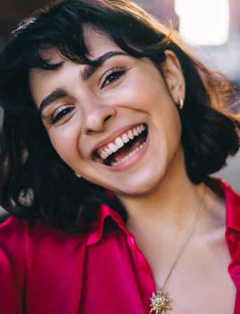 Patient smiling after receiving prompt emergency dental treatment