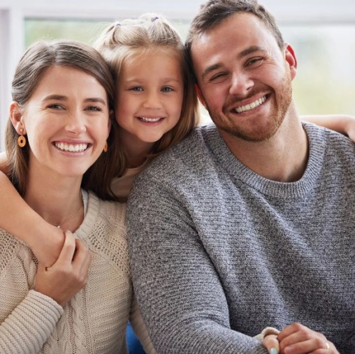 Happy family smiling after receiving comprehensive general dentistry services