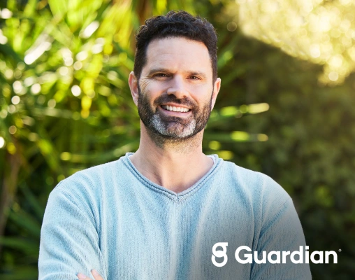 Smiling man representing patients with accepted Guardian dental insurance coverage.