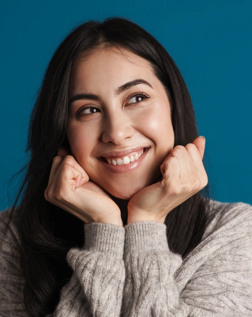 Smiling woman representing a patient after gum disease treatment.