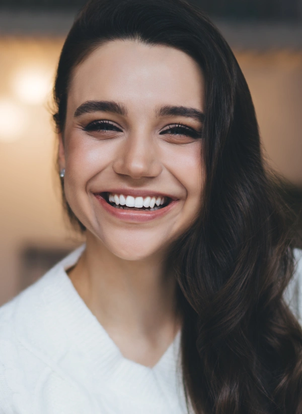 Smiling patient sharing a five-star review and positive dental experience at Powers Dental Group
