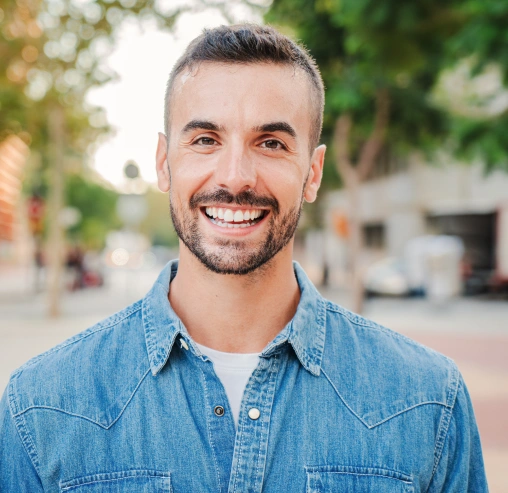 Smiling patient showing results of professional teeth whitening treatment